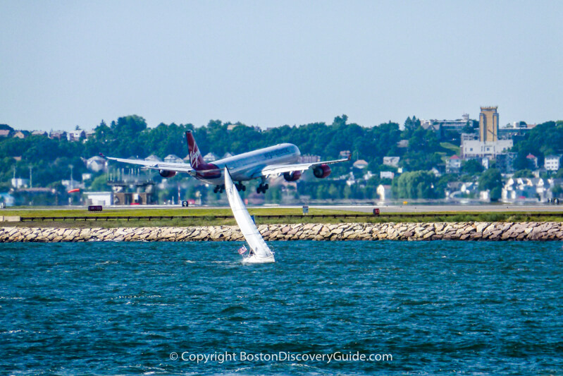 Virgin Airlines flight landing at Boston Logan Airport across from Castle Island