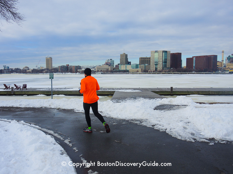 Winter walking tour of Boston: Jogger along the Esplanade, next to the frozen Charles River