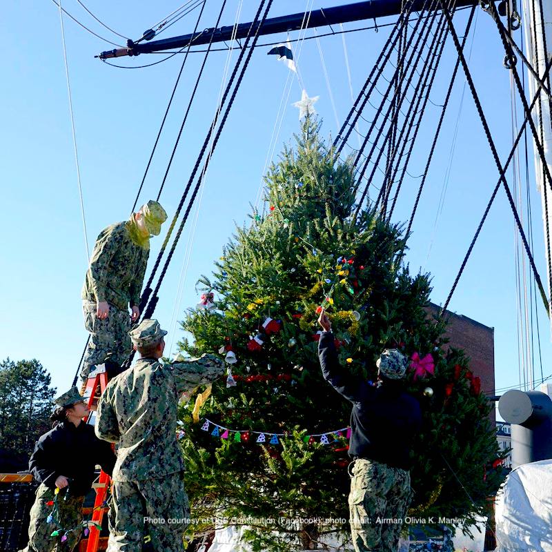 Sailors assigned to the USS Constitution decorate Old Ironsides' Christmas tree before the lighting ceremony
