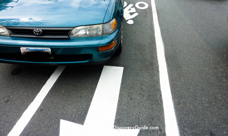 Car driving in bike lane along Commonwealth Avenue near Boston University